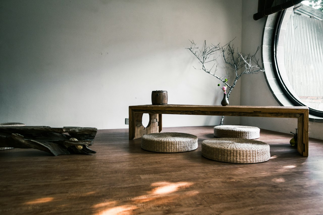Pièce épurée avec table basse, coussins et lumière naturelle